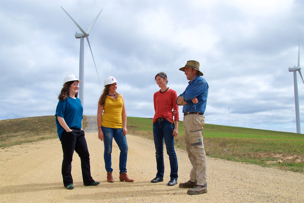 CPA staff with landholder standing in front of wind farm